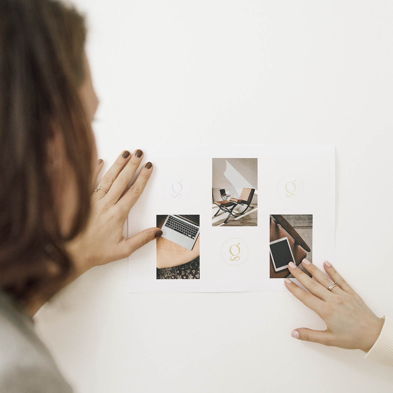 Hands arranging branding materials and design mockups for a Glasswing Collective project.
